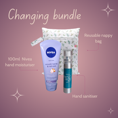 Changing bundle with Nivea hand moisturiser, hand sanitiser and reusable nappy bag on a pink background