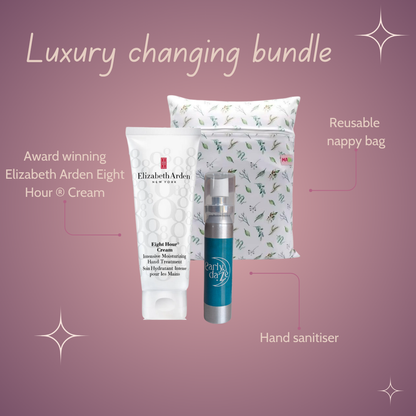 Luxury changing bundle with Elizabeth Arden Eight Hour Cream, reusable nappy bag, and hand sanitiser on a pink background.